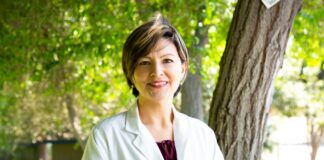 woman standing under tree