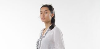 a woman in a white shirt and blue jeans