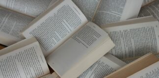 white and brown book on brown woven surface
