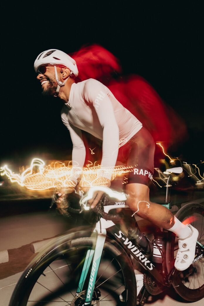 Cyclist enjoying a fast ride at night.