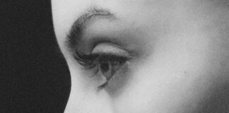 grayscale photo of womans face