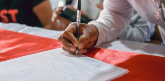 a person writing on a piece of paper