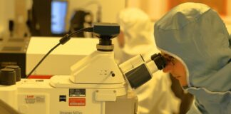 man using microscope