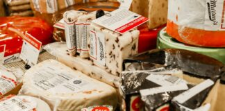 a table topped with lots of different types of cheese