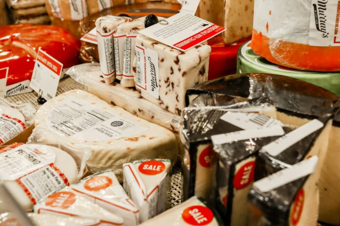 a table topped with lots of different types of cheese