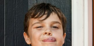 boy with brown hair and red lip stick