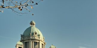 a car is parked in front of a large building