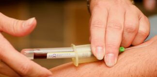 person injecting syringe