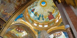 The inside of a church with paintings on the walls