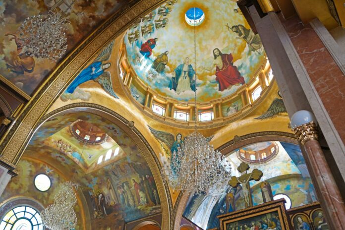 The inside of a church with paintings on the walls