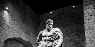 a black and white photo of a statue of a man