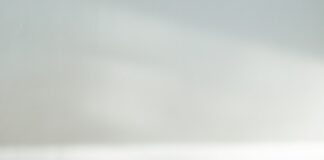 clear framed eyeglasses on top of pile of books