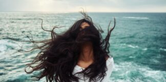 woman standing near body of water during daytime