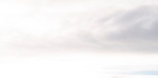 aerial view of house near body of water during daytime