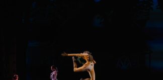 three woman standing on stage on black background