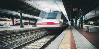 red and white train on rail way during daytime