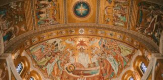 The ceiling of a building with a painting on it