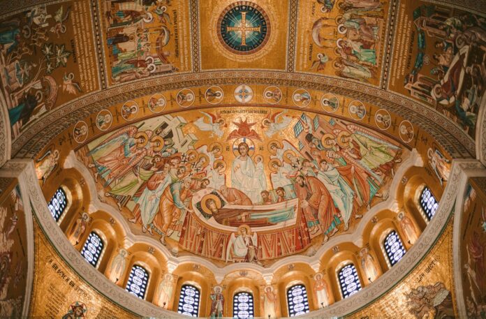 The ceiling of a building with a painting on it