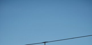 a person riding skis on top of a ski lift