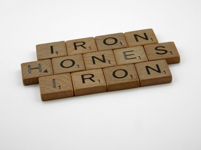 a scrabbled word that says iron, bones, iron on a white
