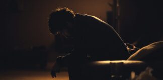 man in black shirt sitting on chair