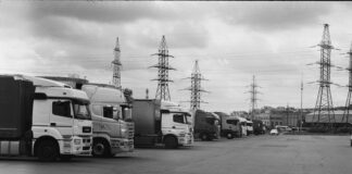 a black and white photo of trucks parked in a lot