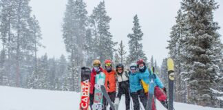 people in blue and red jacket and pants standing on snow covered ground during daytime