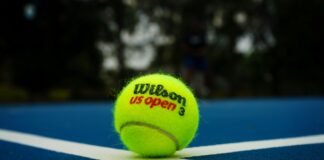 a tennis ball on a tennis court with the words wilson us open written on it