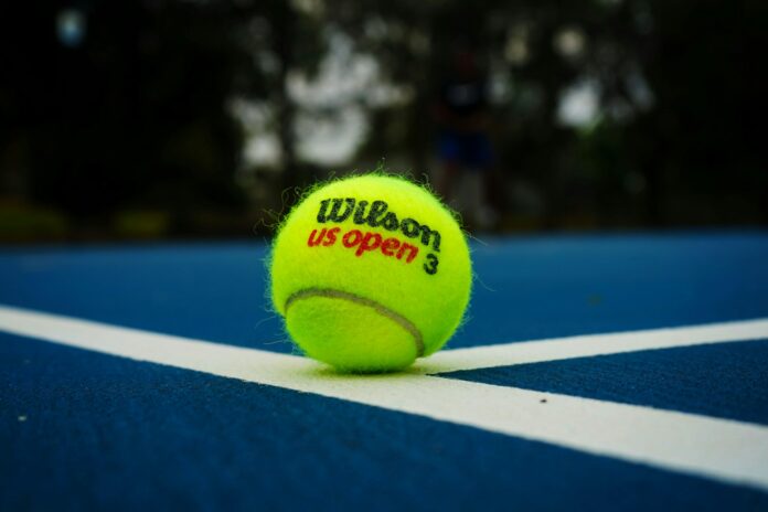 a tennis ball on a tennis court with the words wilson us open written on it