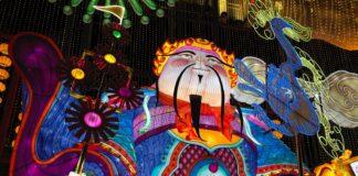 A colorful statue of a person with a cane