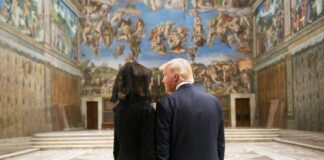 man in black suit standing beside woman in black dress