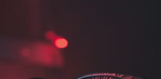 black wayfarer sunglasses on black surface