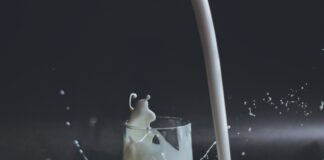 white candle in clear glass holder