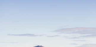houses near mountain under white sky during daytime