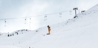 A person on skis going down a snowy hill