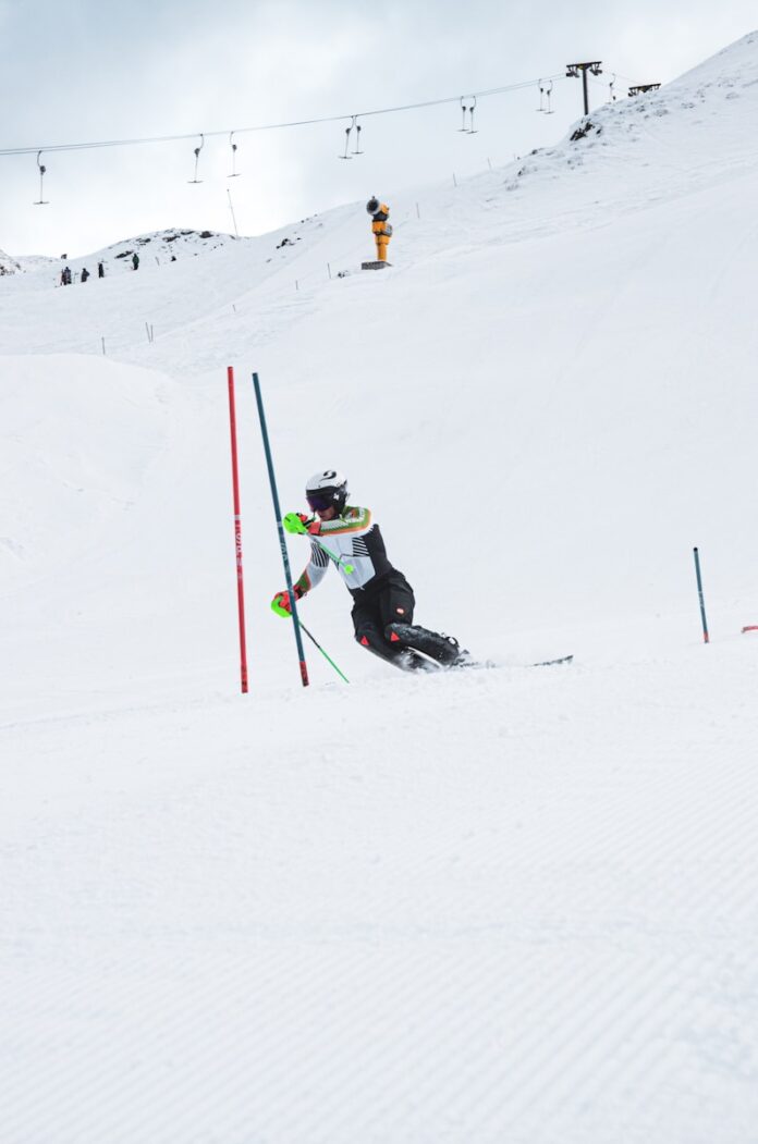 A person on skis going down a snowy hill