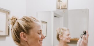 woman in white towel holding mans hand