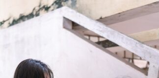 woman in white button up shirt holding white book