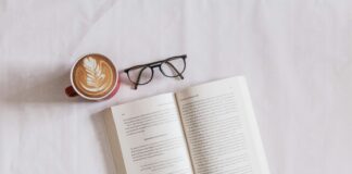 book near eyeglasses and cappuccino
