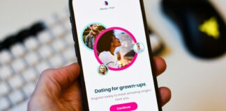 a person holding a cell phone in their hand