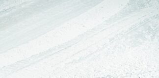 a man riding skis down a snow covered slope