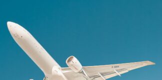 white airplane under blue sky during daytime