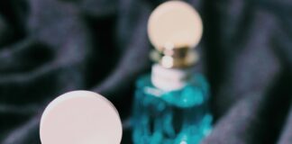 three green and pink bottles on black textile