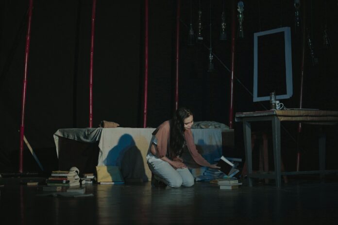 a woman sitting on a couch in a dark room