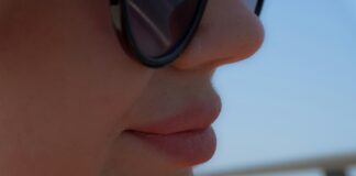 Close-up profile of a woman wearing sunglasses