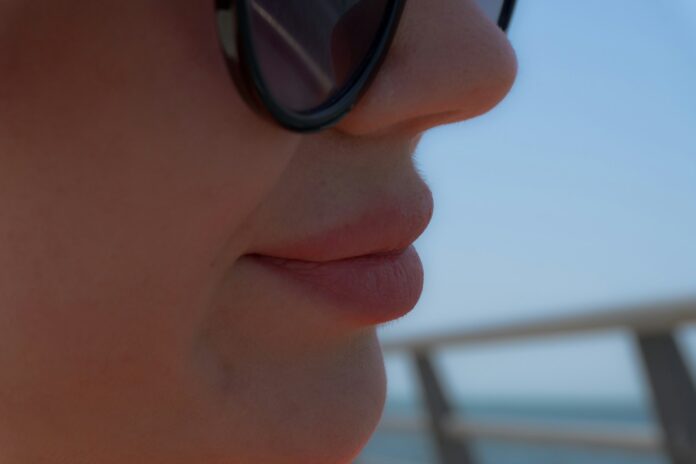 Close-up profile of a woman wearing sunglasses