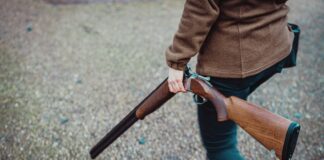 a person holding a rifle in their hand