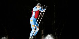 man in blue and red jacket and blue pants riding on snowboard