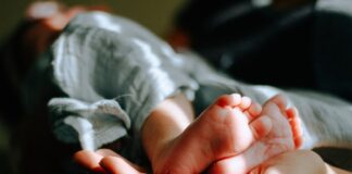 person holding baby feet