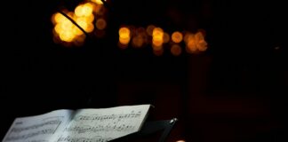 an open sheet of music sitting on top of a table